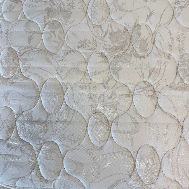 Close-up of the quilted floral damask top of the mattress