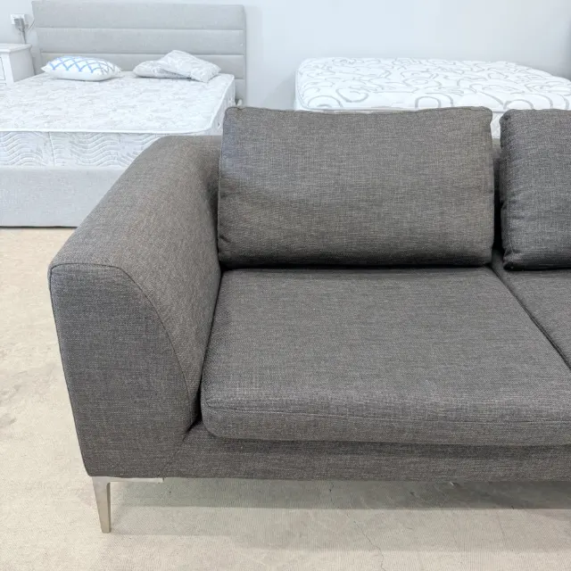 Slim track arm, back cushion and brushed metal leg of the Freedom sofa