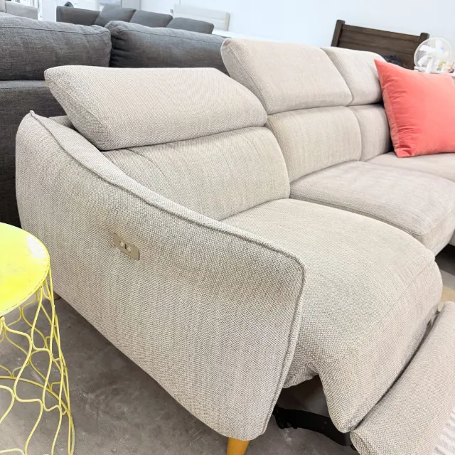 Recliner end of the Freedom sofa with the power button on the arm and the footrest out