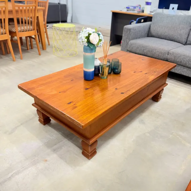 Rustic pine coffee table, three-quarter view with chunky block legs