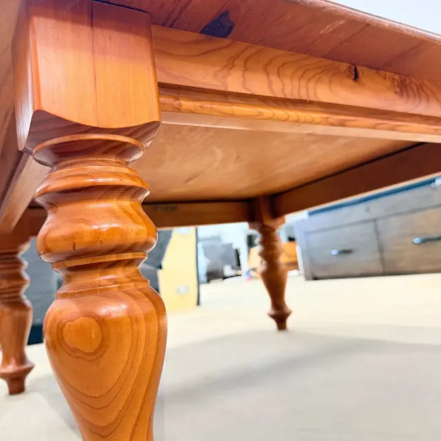 Low view under the table: turned leg and apron