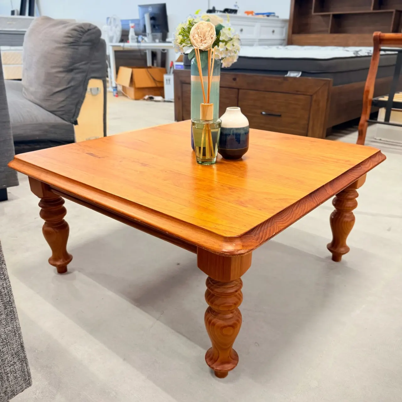 Square pine coffee table with turned legs, three-quarter view