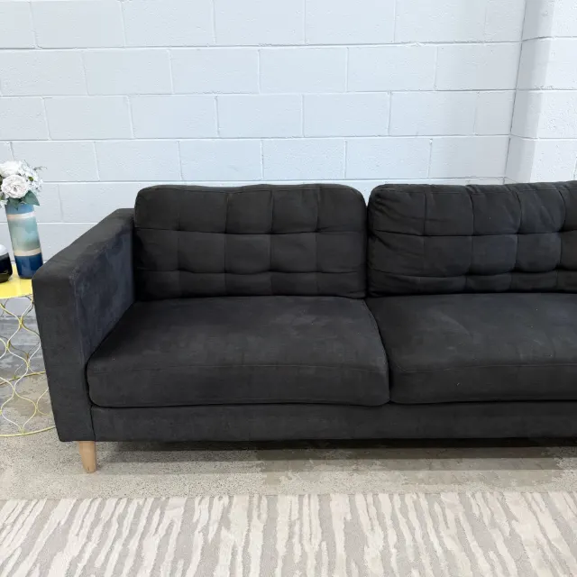 Front view of the two-seat section with stitched-grid tufted back cushions