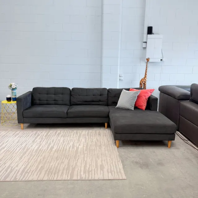 Charcoal L shape chaise sofa, straight-on front view with grey and coral cushions