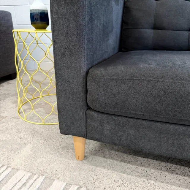Square arm, seat cushion and light timber leg close-up