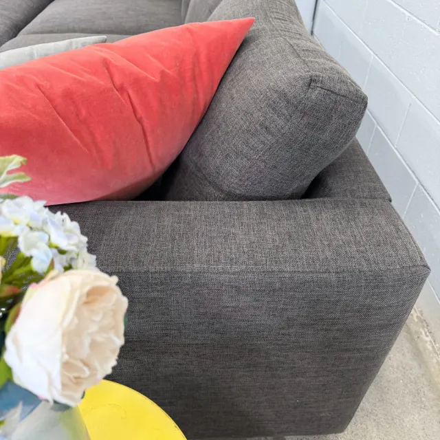 Square arm and back cushion close-up in charcoal grey fabric