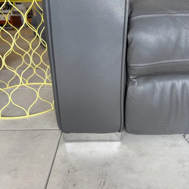 Chrome foot under the grey leather recliner