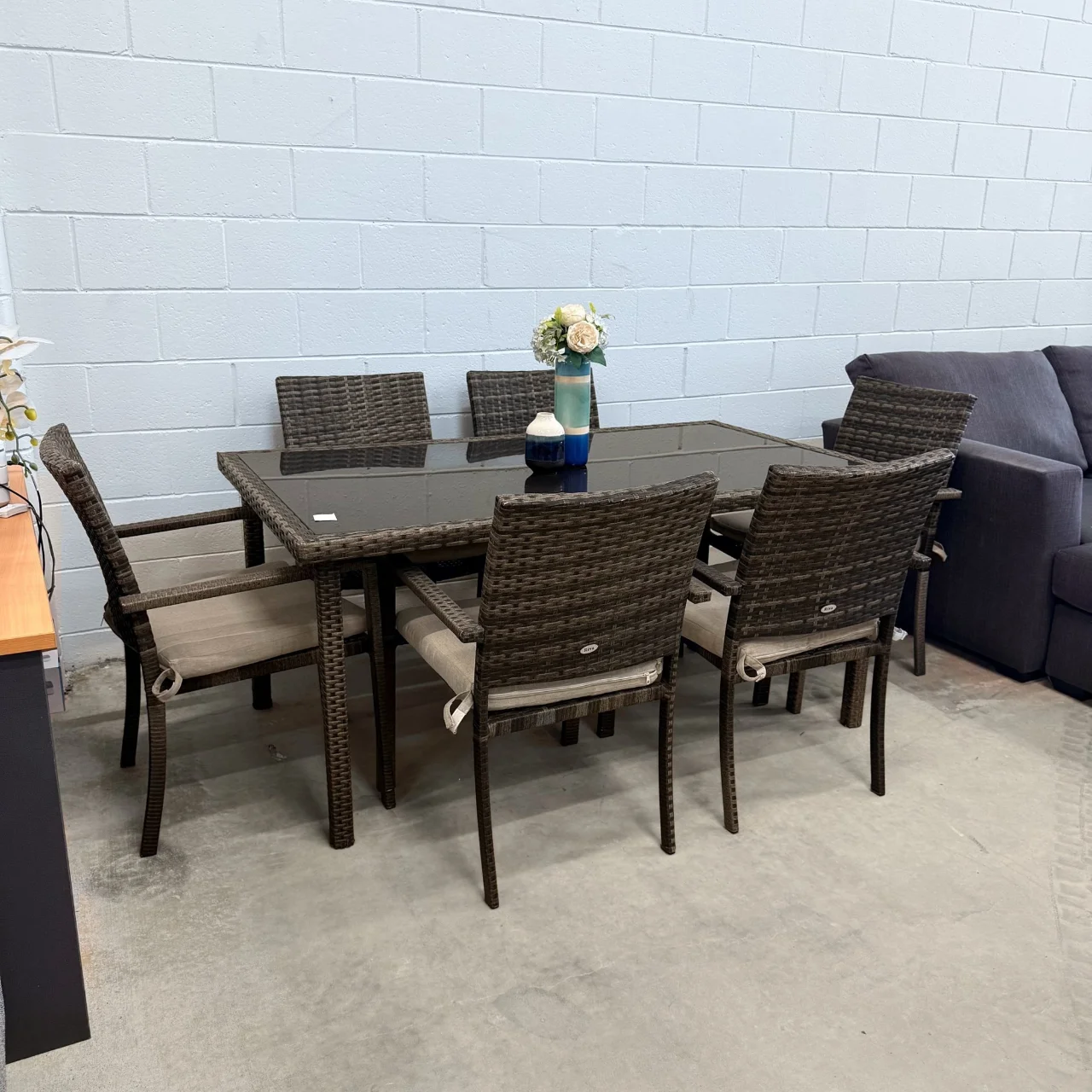 Riva 7-piece outdoor wicker dining set from the left, black glass-top table with 6 armchairs