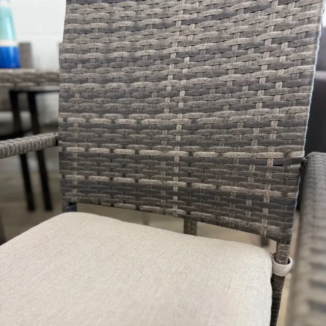 Wicker chair back and beige seat cushion close-up