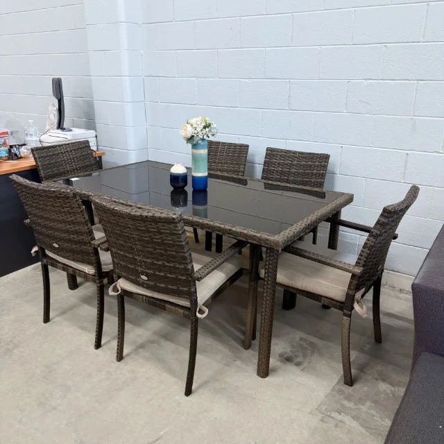 Riva outdoor dining set from the right corner, glass table and cushioned wicker armchairs