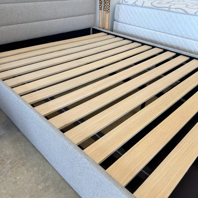 Timber slat base inside the upholstered queen frame