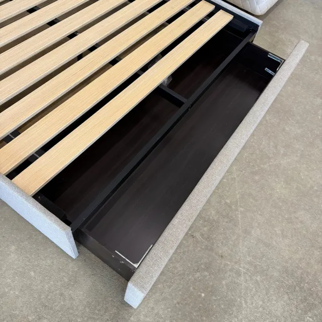 Big pull-out storage drawer at the foot of the bed, seen from above