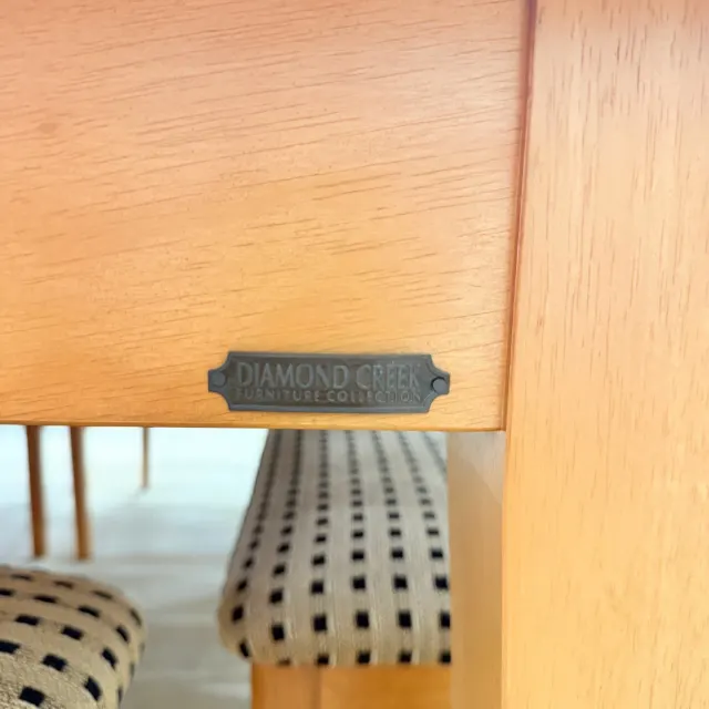 Diamond Creek Furniture Collection badge on the table apron