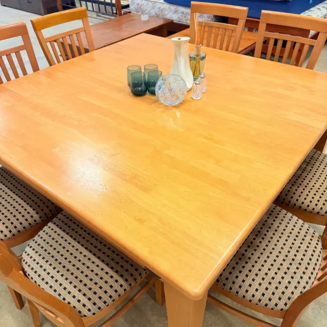 Honey timber table top seen from above with chairs around it