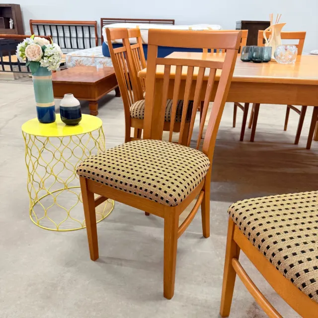 Slat-back dining chair with black and beige patterned seat