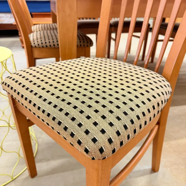 Close-up of the upholstered chair seat in black and beige weave