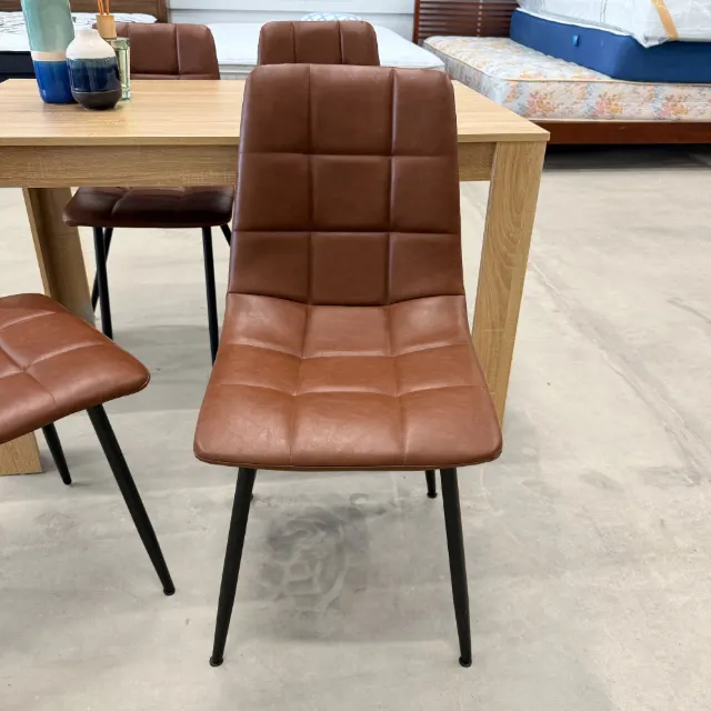 Tan faux leather dining chair with quilted back, front view