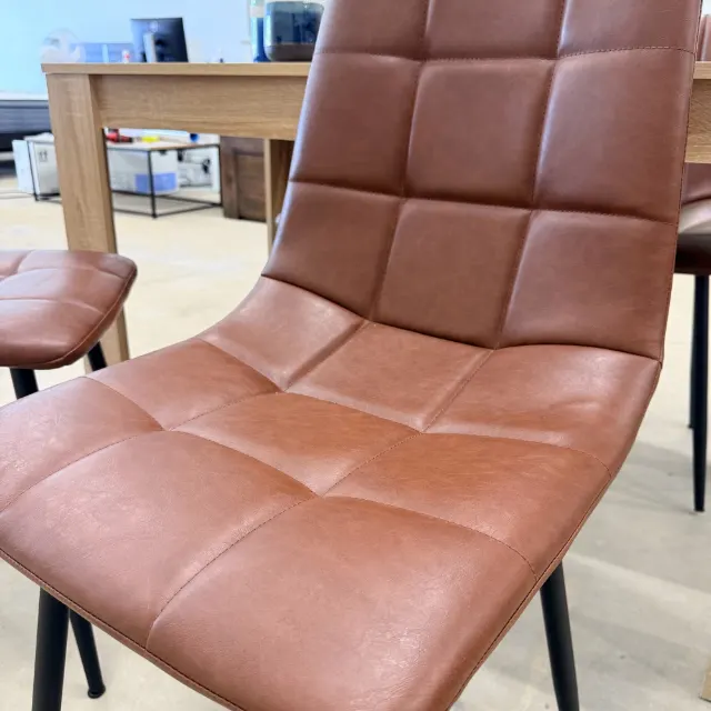 Close-up of the padded, quilted chair seat