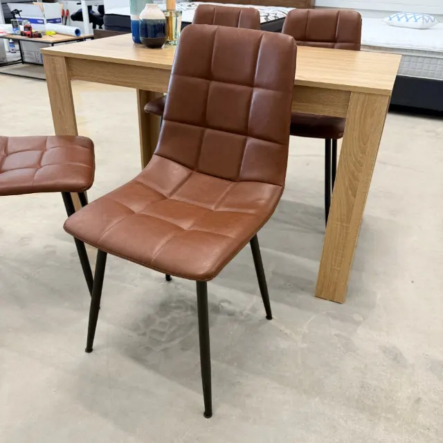 Tan faux leather dining chair, three-quarter view