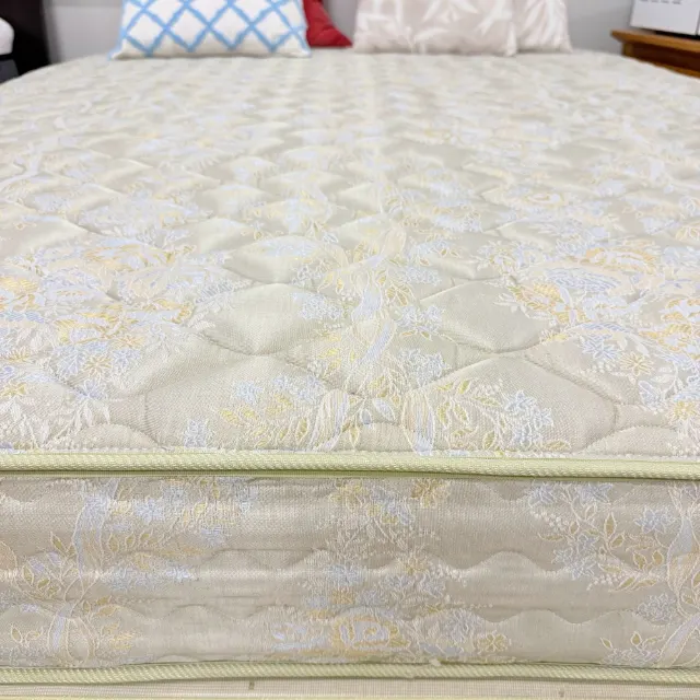 Mattress side and the base's piped edge in matching cream damask
