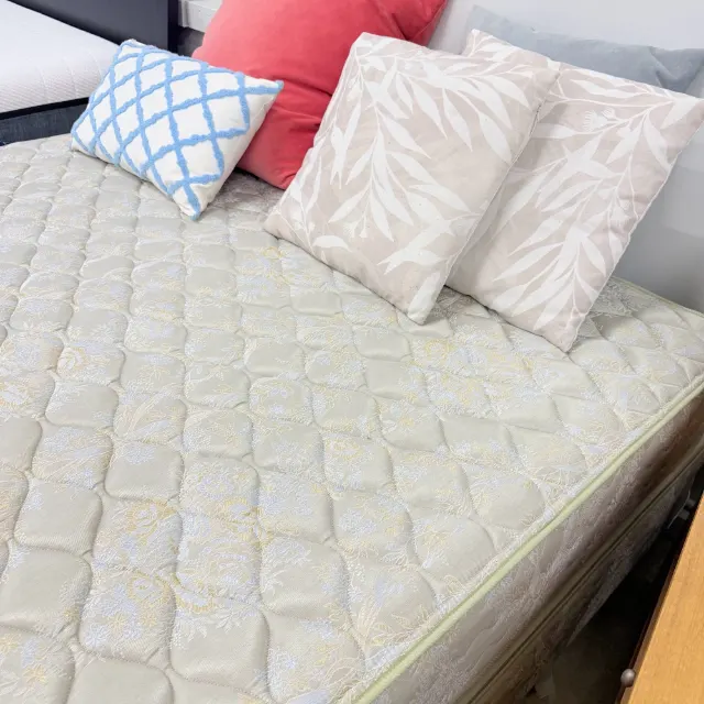 Quilted damask top of the queen mattress, styled with cushions