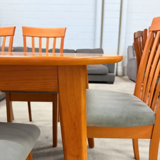 Low view of a table leg and a padded dining chair