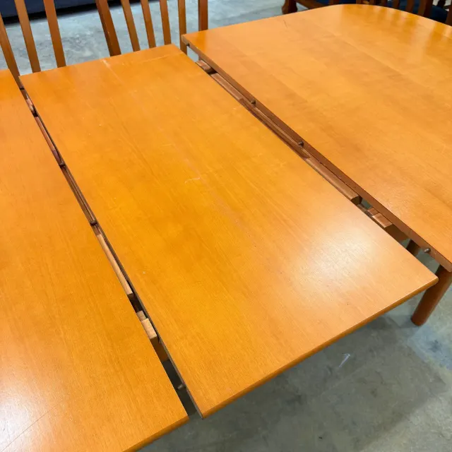 Table pulled apart showing the extension leaf and runners