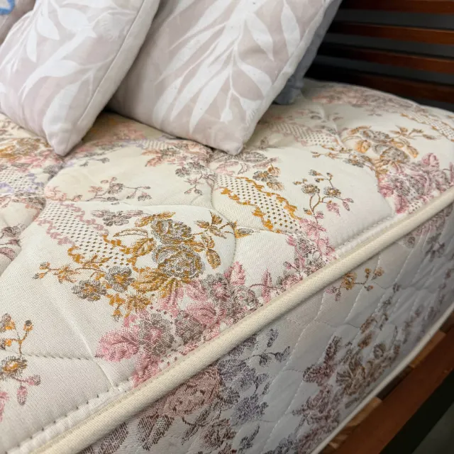 Quilted edge and side of the Sealy queen mattress
