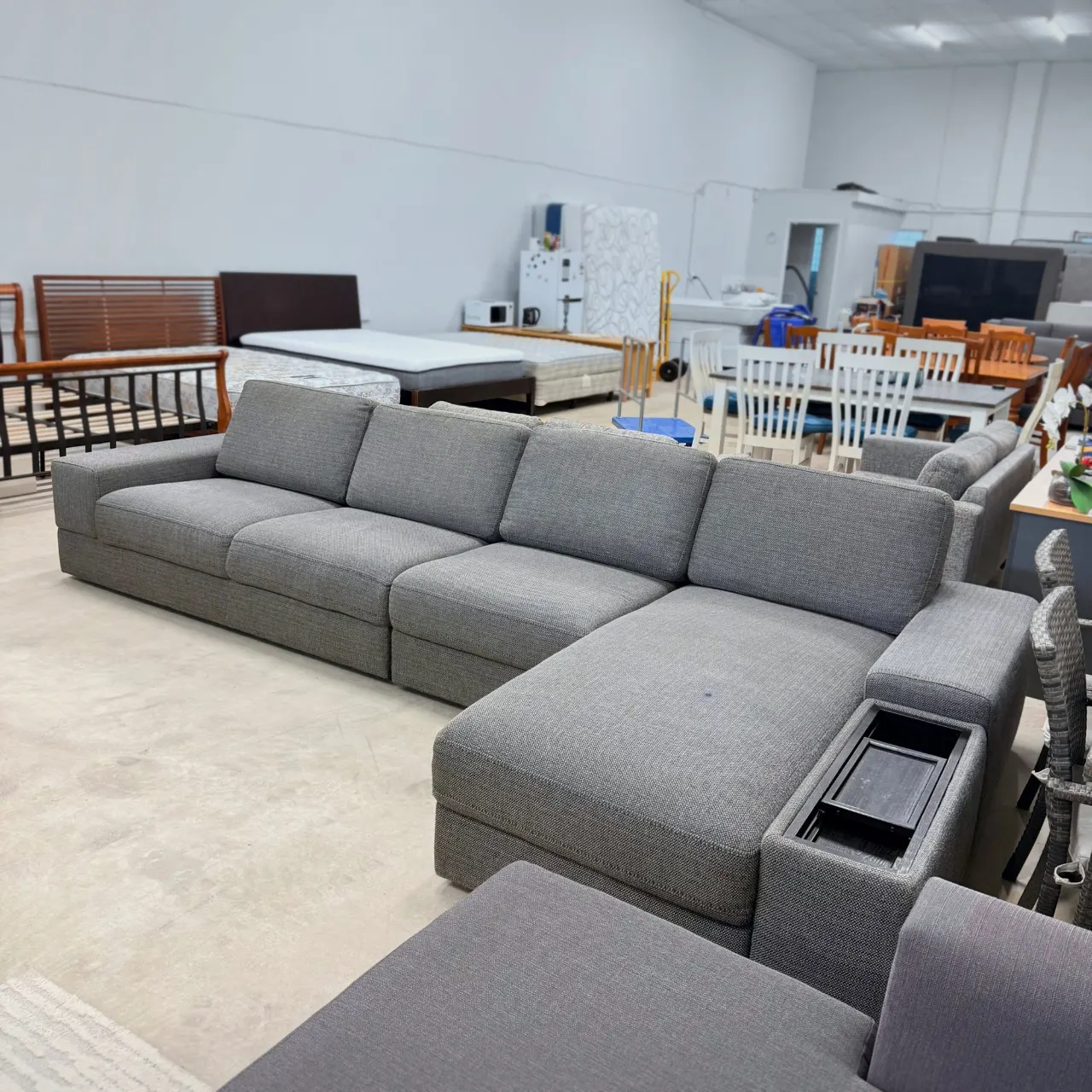 Grey L shape sofa from the chaise end, with the storage arm