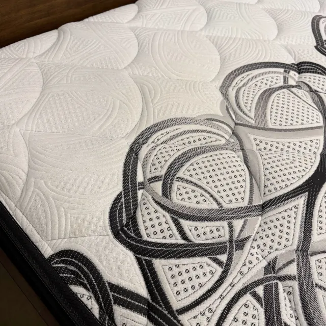 Close-up of the soft quilted top and swirl stitching at the mattress corner
