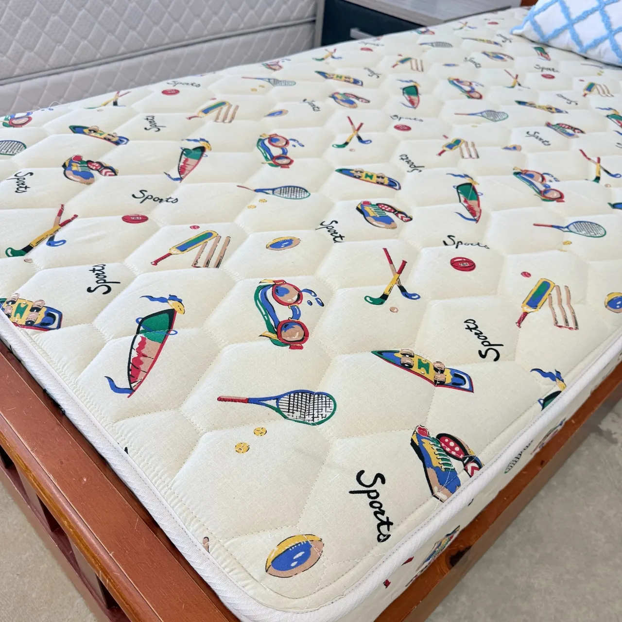 Single mattress with a fun sports-print quilted cover