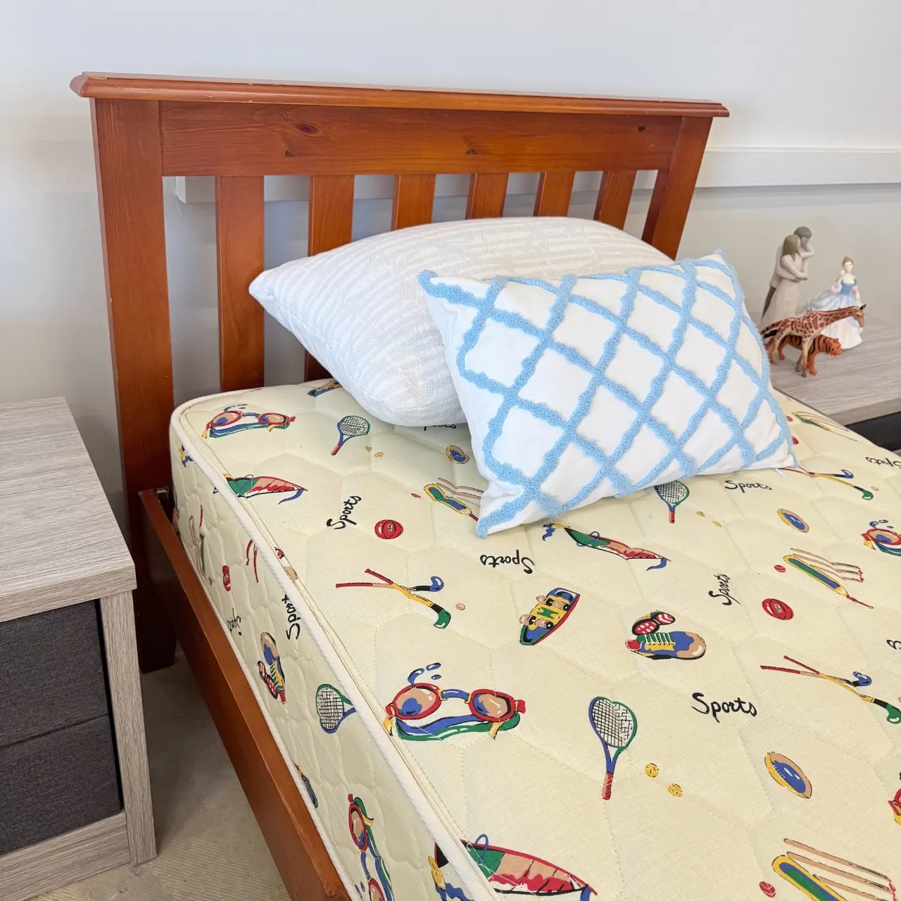 Sports-print single mattress with pillows, close-up