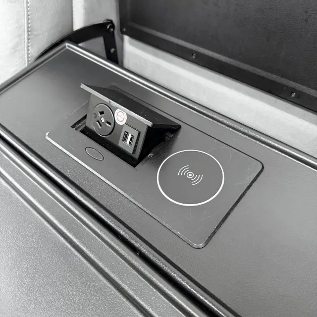 Close-up of the wireless charging pad, power point and USB ports