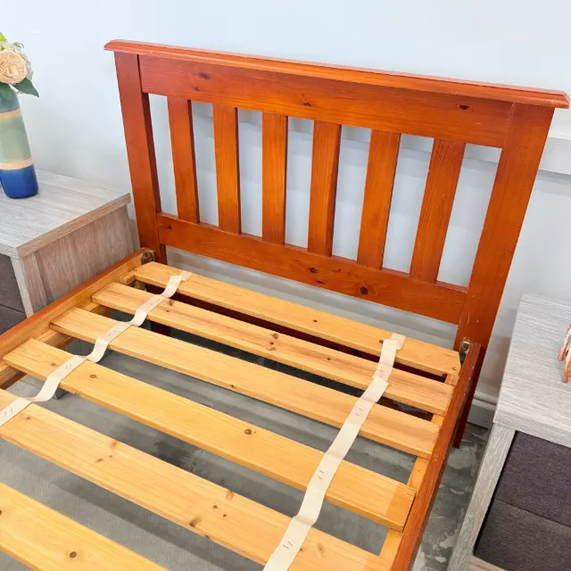 Timber single bed frame from above: slatted headboard and pine slats with spacer straps