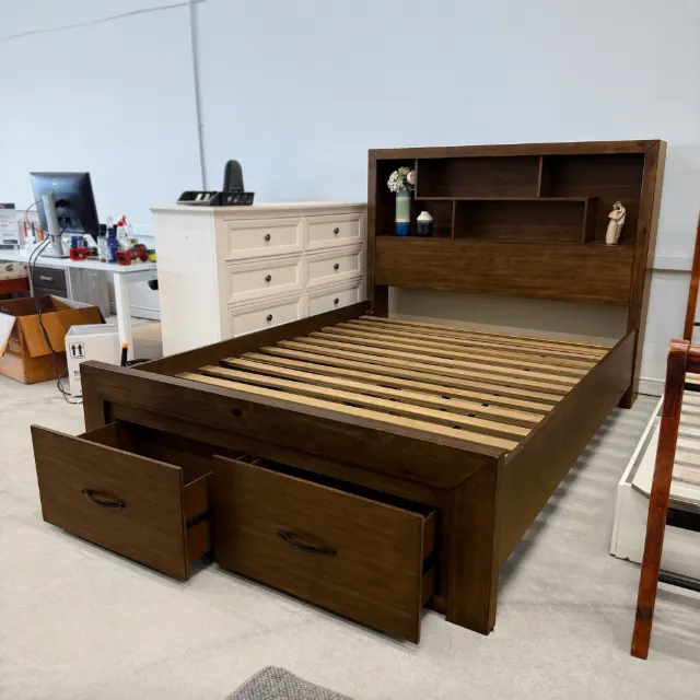 Walnut queen storage bed seen from the foot corner, drawers open and slatted base