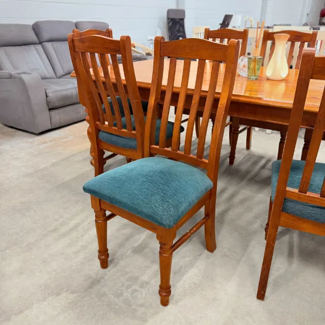 Timber dining chair with slatted back and turned front legs, angled view
