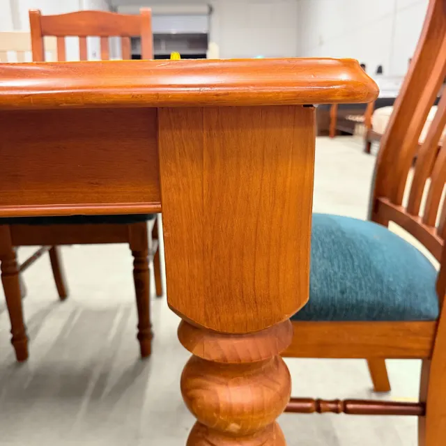 Close-up of the table's chunky turned leg and apron