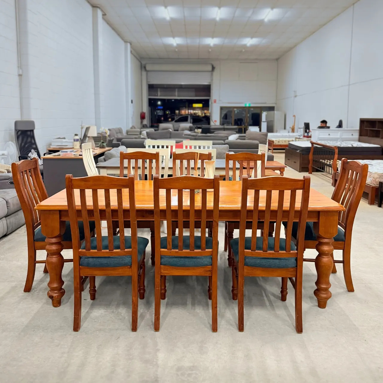Timber 9-piece dining set: farmhouse table with eight high-back chairs, front view