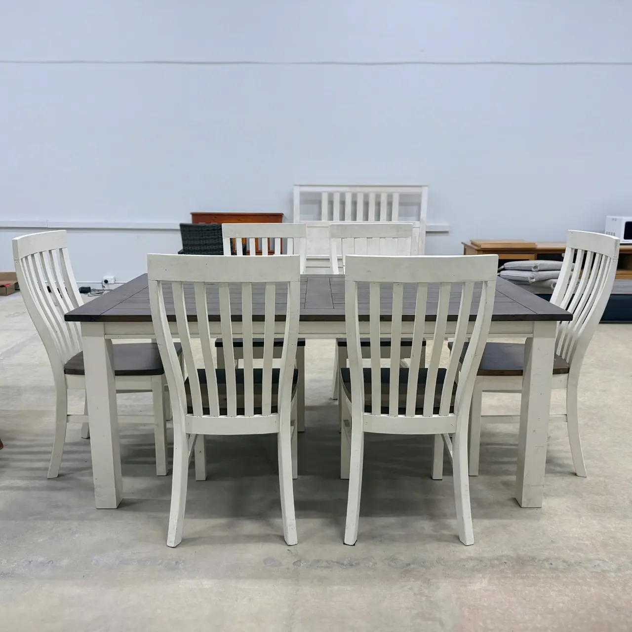 White 7-piece dining set with dark timber-look table top, front view